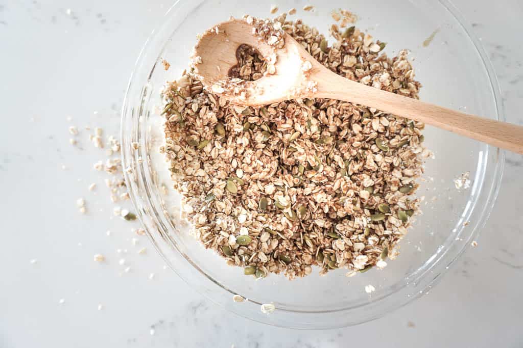 Overhead shot of uncooked breakfast granola in a mixing bowl