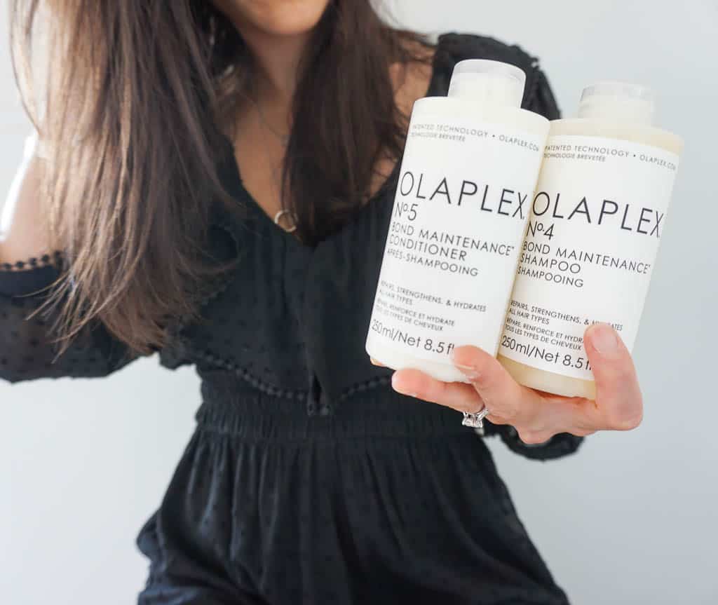 Image of olaplex shampoo and conditioner in the foreground with Signed Samantha holding them in the background showing off her fine straight hair.