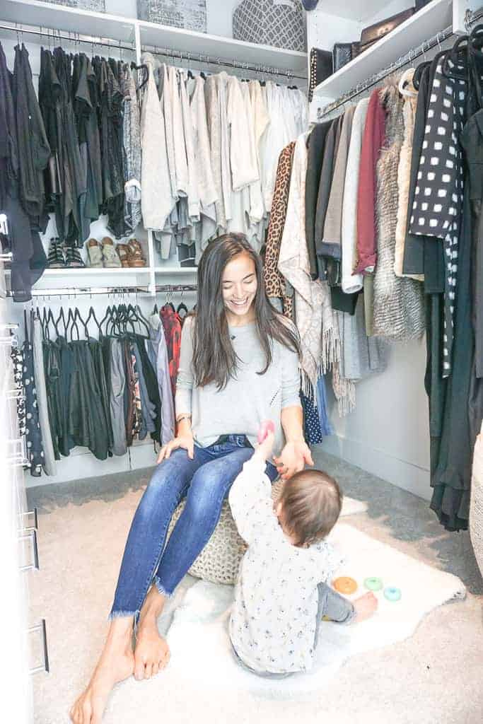 Fall Closet Overhaul in Signed Samantha's closet. Her and her daughter are playing in the closet on the ground. All the clothes are color coordinated.