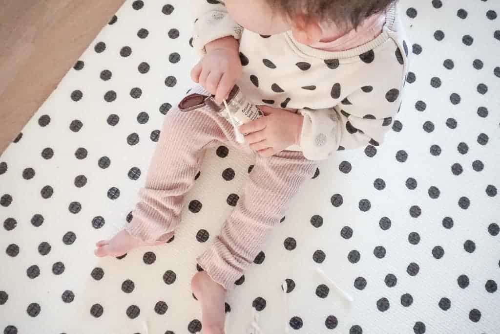 Signed Samantha's Easy and Free Toddler Activities includes putting q-tips into a spice shaker which is what her daughter is holding.