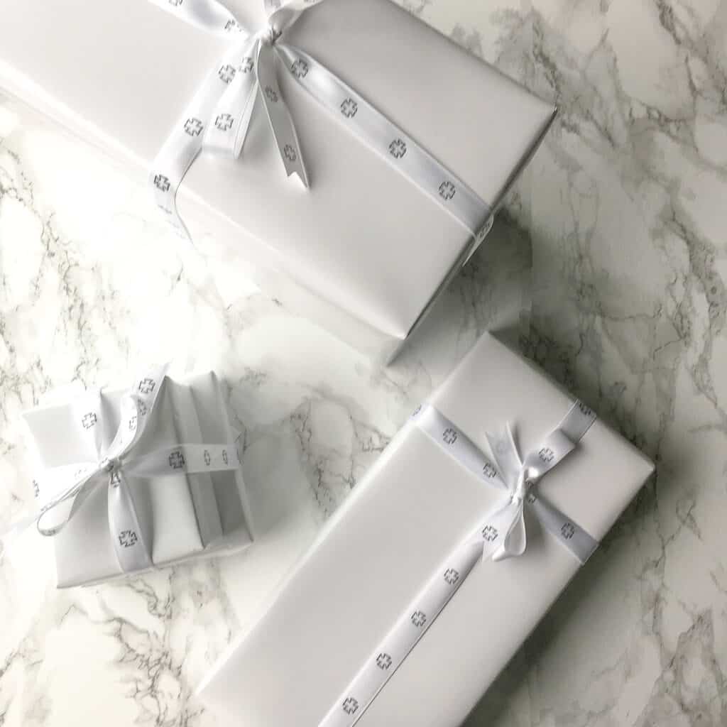 Part 2 of 5 of Signed Samantha's Gift Guide for The Ultimate 2020 Gift Guide: Friends, Colleagues and Kids. Three gifts wrapped in white.