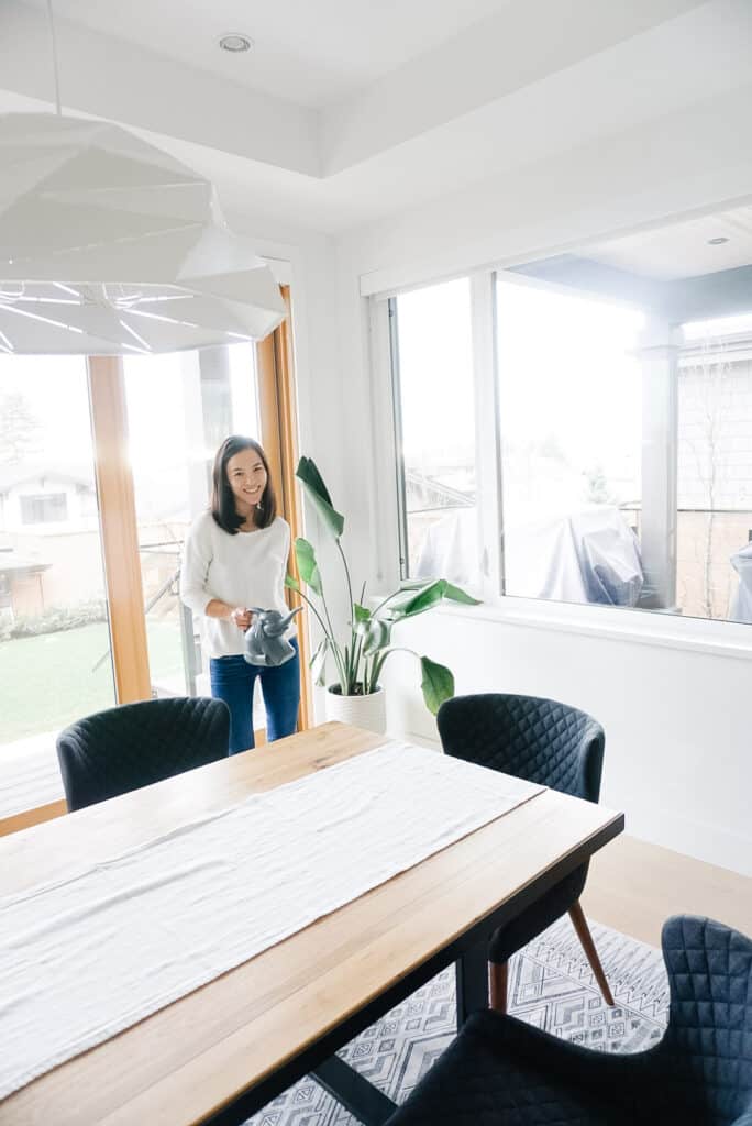 Signed Samantha's dining room tour - she is watering one of her few plants in the corner