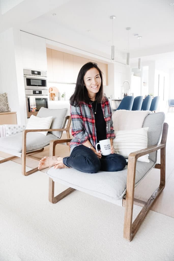 Signed Samantha's January Champagne Chats (Q&A) as she is sitting on a chair in the living room(with the kitchen in the background)