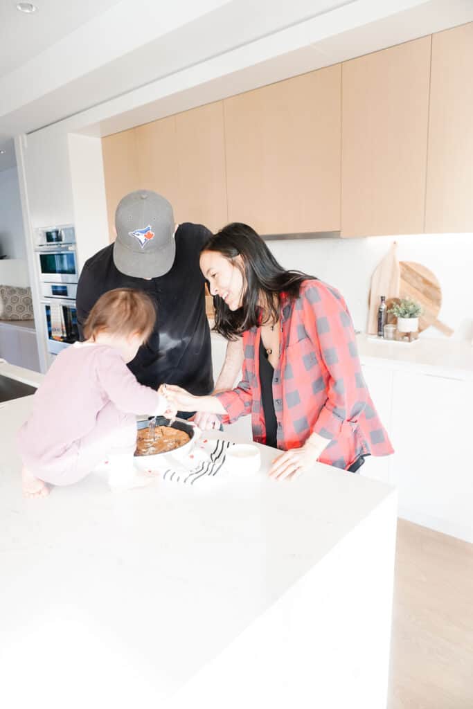 Signed Samantha and her family enjoying a gluten-free chocolate chip skillet cookie in the kitchen