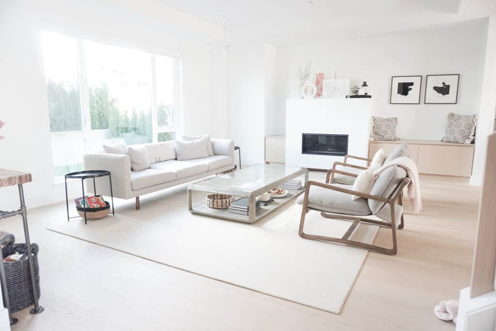 Signed Samantha gives a living room tour - here is she sharing a full shot of her living room including a sofa, coffee table, two chairs, and end tables. Everything is neutral in colour.