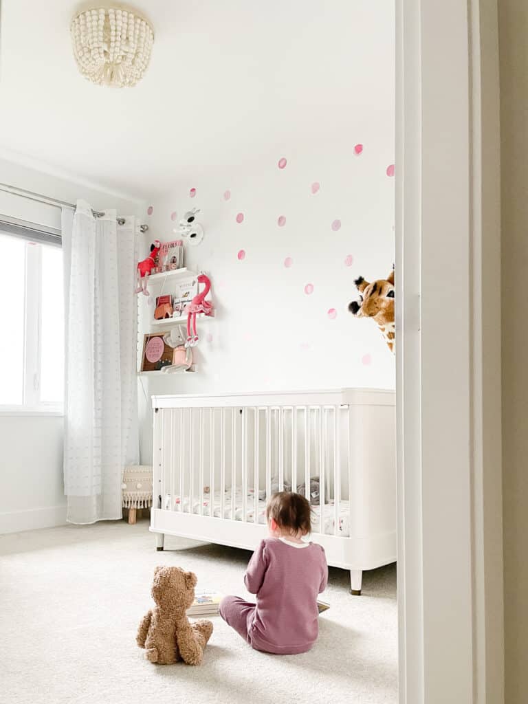 Sloane, signed samantha's toddler, sitting in her brighton handmade lounge set, from one of the local vancouver shops for kids wear. She is on the floor in her room reading with her teddy bear.