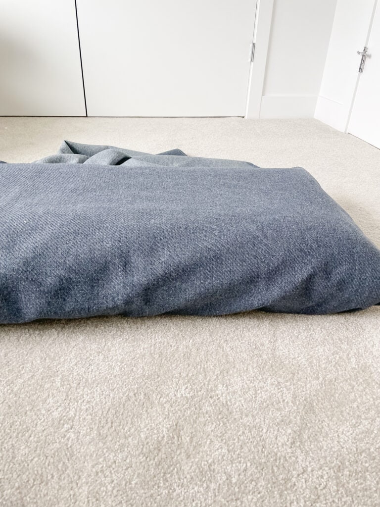 DIY bench cushion cover - demonstrating the fabric pulled over the cushion