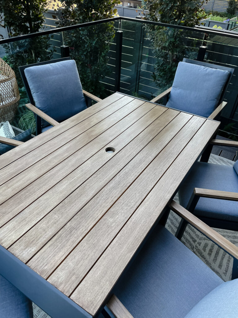 Signed samantha's newly restained patio table. It is stained a rustisc brown natural wood like colour.