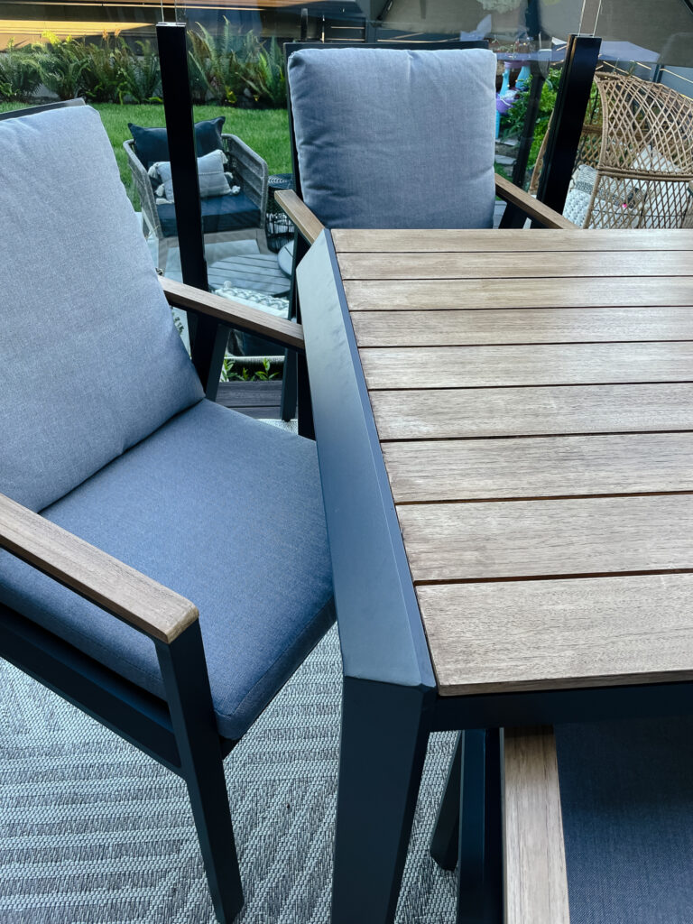 Signed samantha's newly restained patio table. It is stained a rustisc brown natural wood like colour.