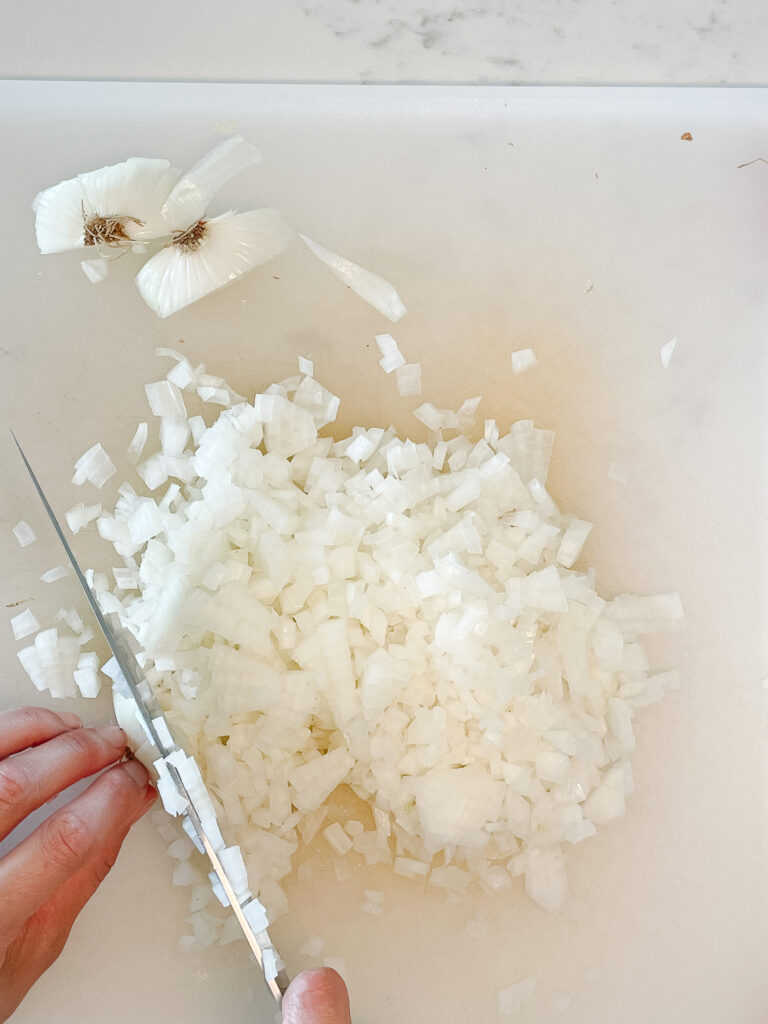 how to cut an onion showing perfectly diced and uniform onions.