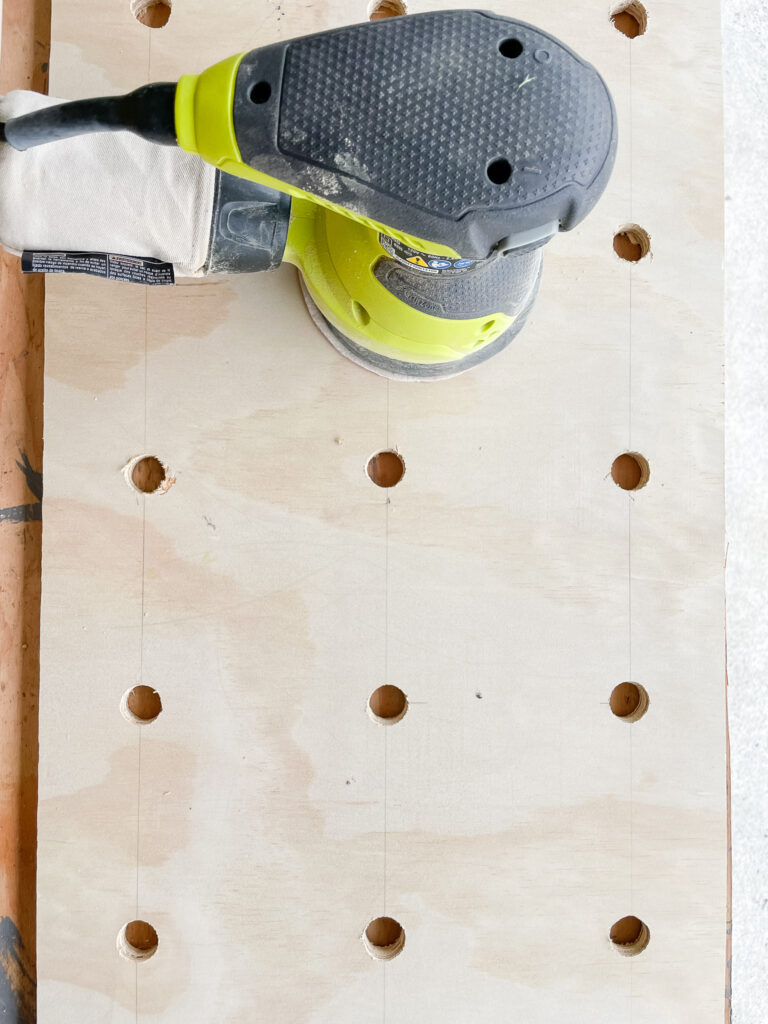 signed samantha showing you progress of her DIY pegboard before she sands it