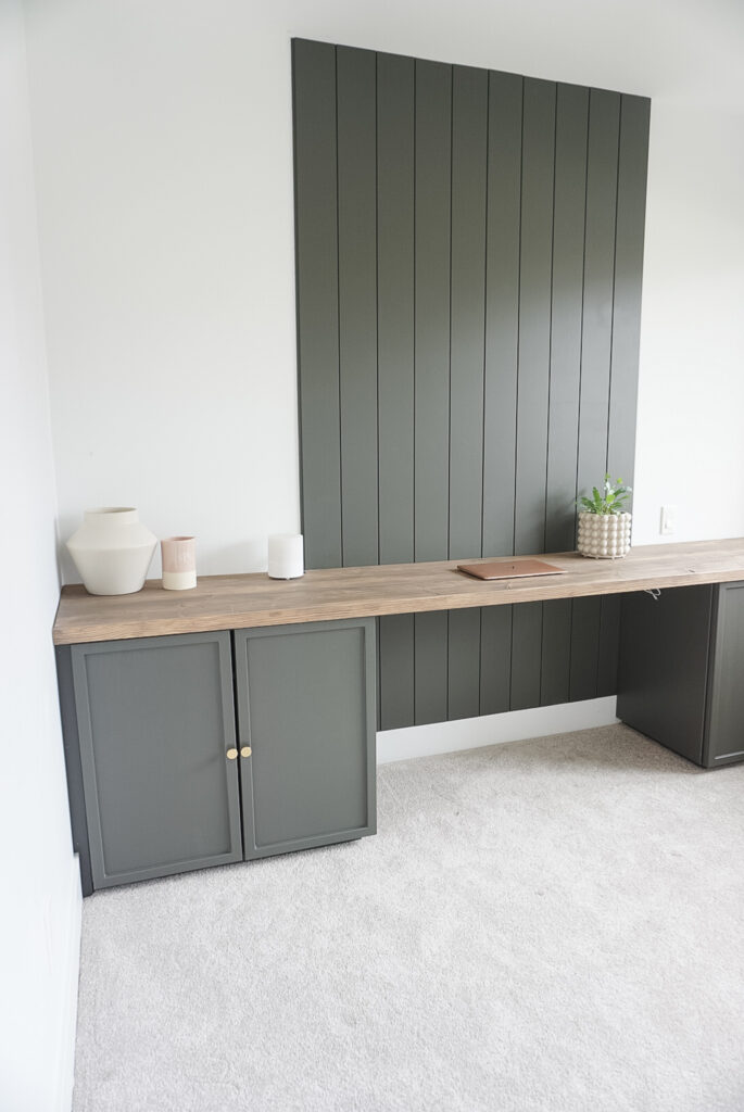 DIY Desk top for week 5 of the one room challenge - rusitc desktop, built in cabinets and a shiplap wall. Not yet done is a bookcase. There are small decor items on the desk.