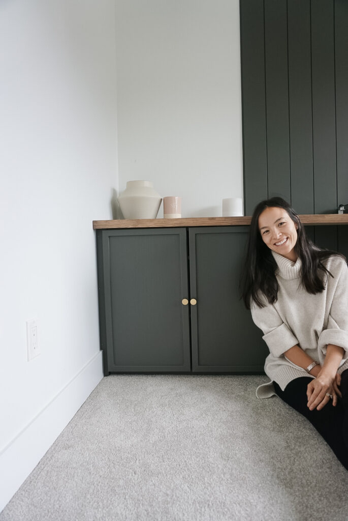 Ikea ivar cabinets but elevated by painted green with trim and hardware. SIgned Samantha sitting next to the cabinet