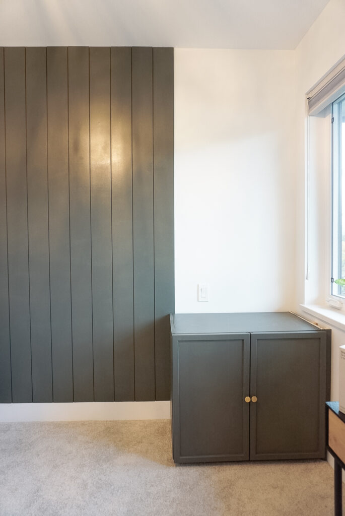 Office reno underway with a cabinet box on the ground and shiplap on a portion of the wall ikea ivar cabinet in the corner