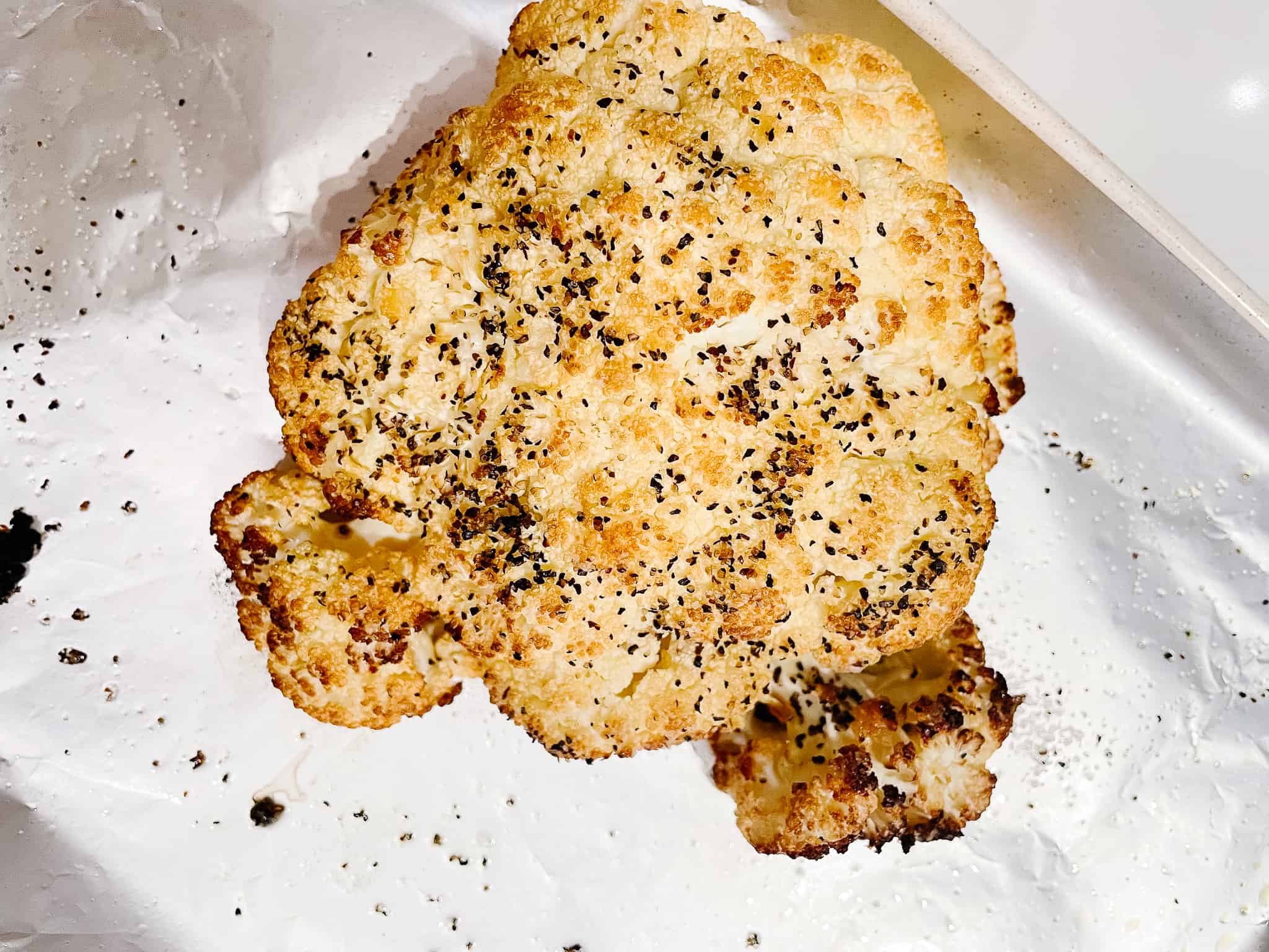 roasted cauliflower fresh from the oven on a tin foil lined tray