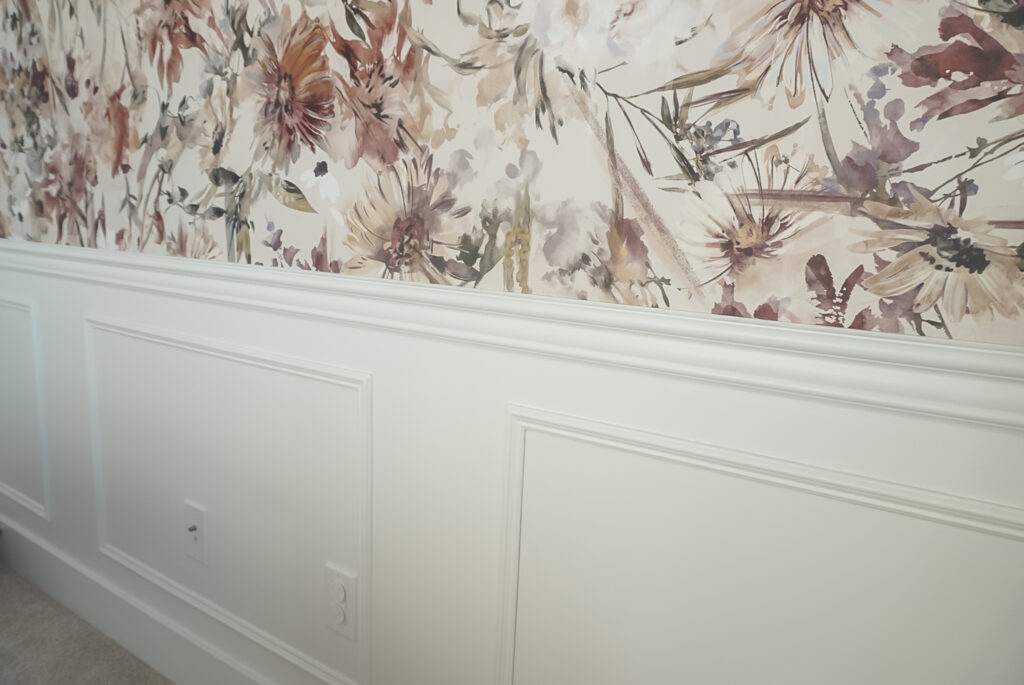 chair rail installed over top a floral wallpaper and box moulding below