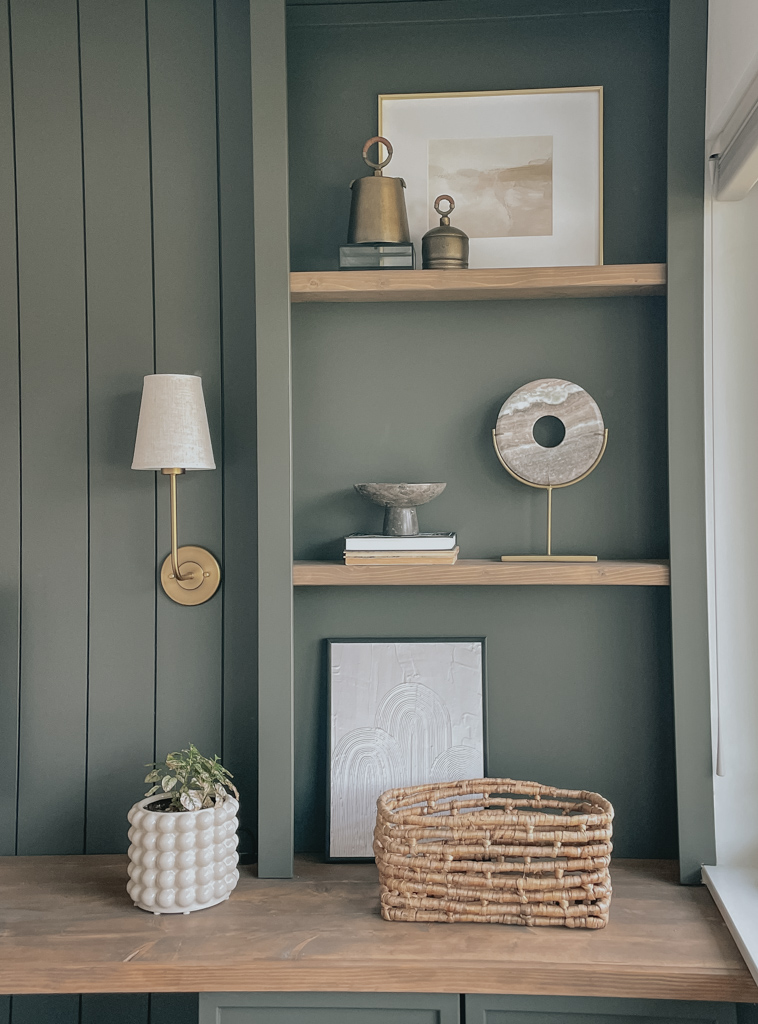 shallow shelves decor ideas. picture frames, baskets, pedestals, bells all on a shallow shelf.