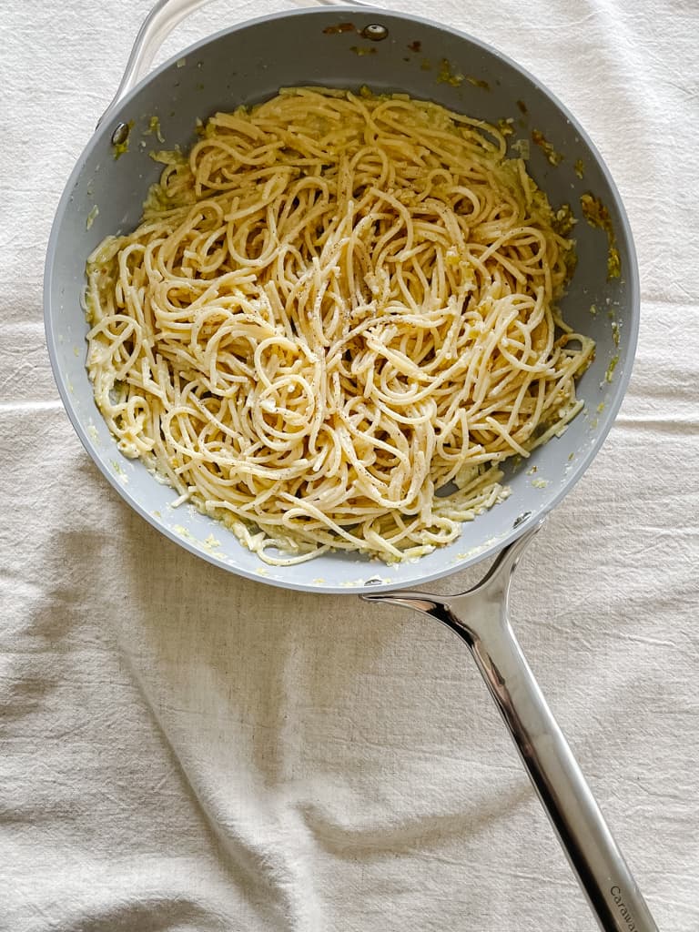 lemon cacio e pepe spaghetti pictured in a sauce pan