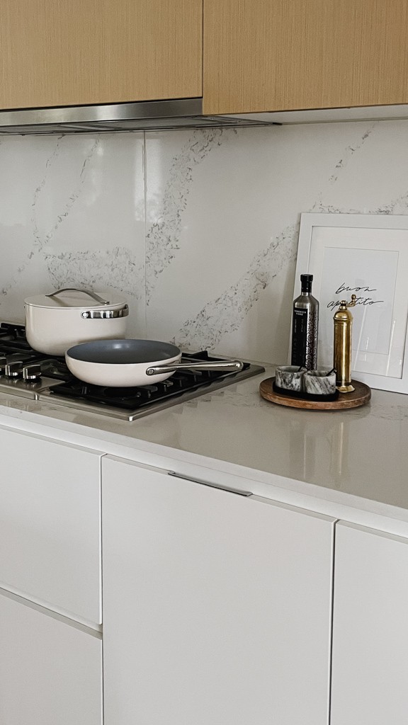 Caraway vs Our Place - caraway pots and pans sitting on a stove top.