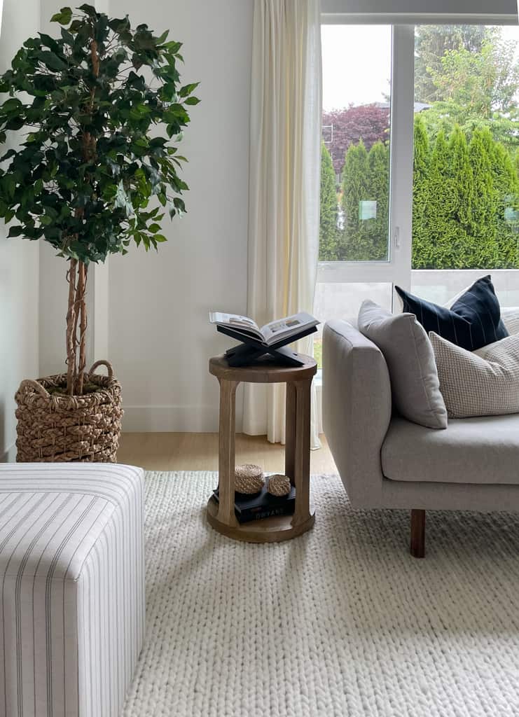 book display styled on top of a side table in the living room