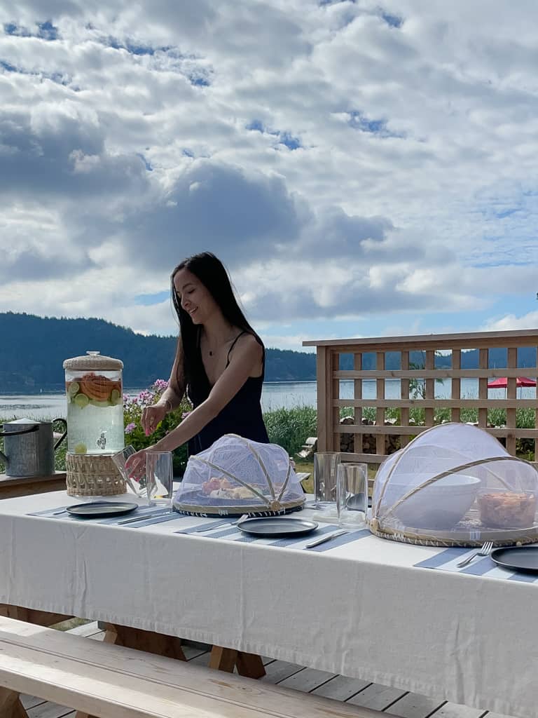 signed samantha pouring a drink from the drink dispenser while entertaining outdoors