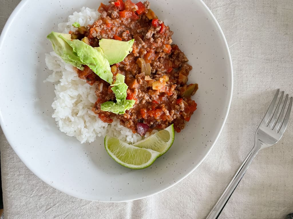 fable dishes with a bowl of rice and avocado and chilli