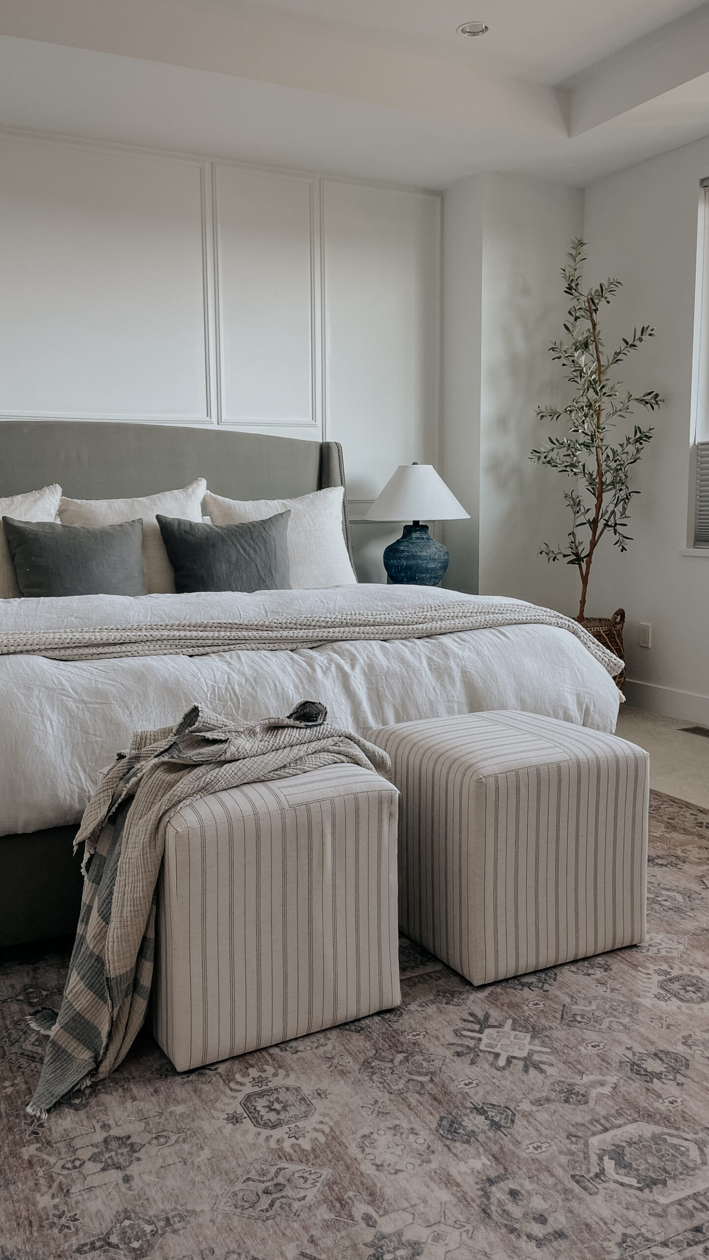 parachute bedding on top of a bed - linen duvet cover and duvet insert with stools at the bottom of the bed