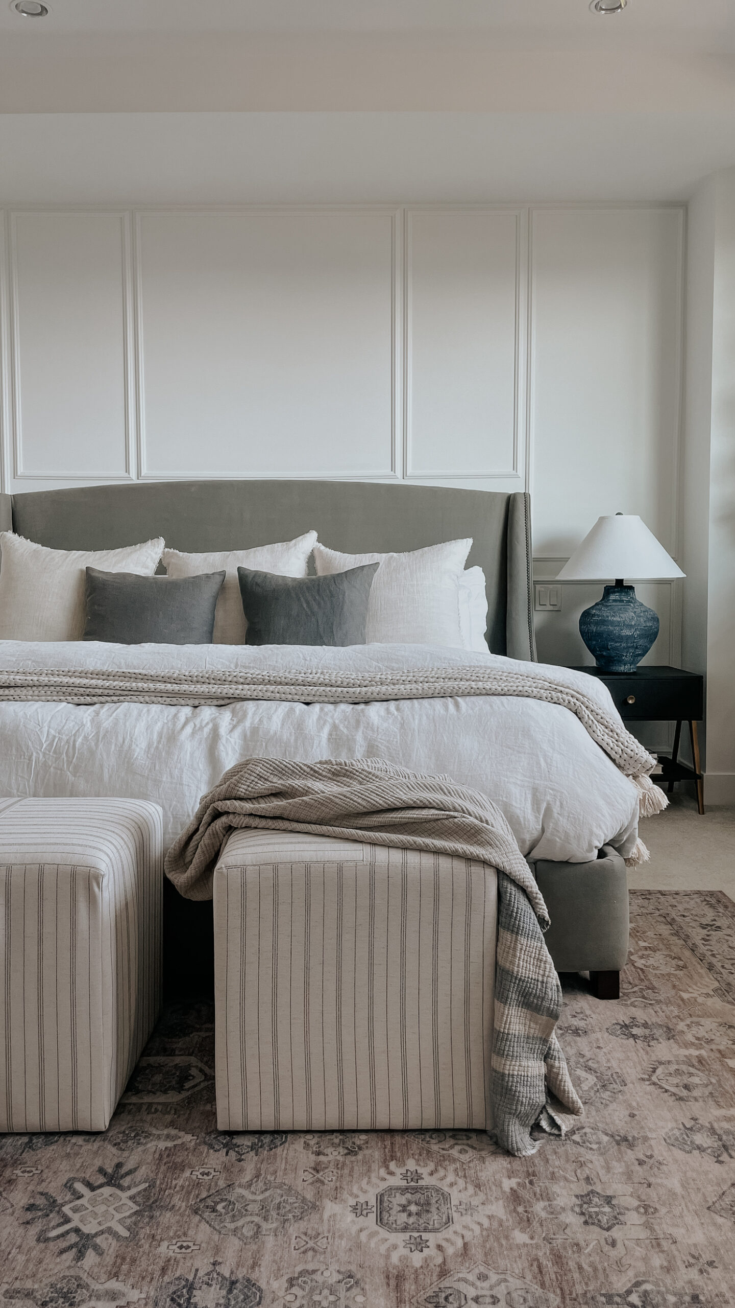 parachute bedding on top of a bed - linen duvet cover and duvet insert with stools at the bottom of the bed