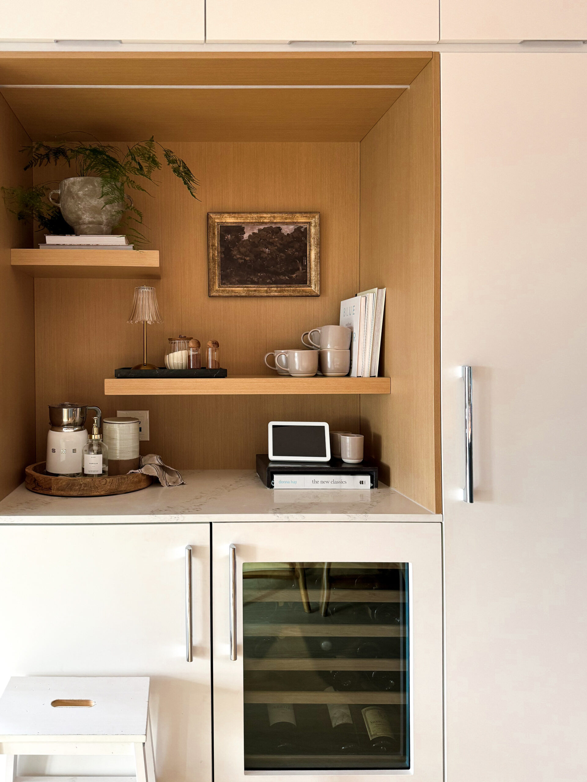 a tea bar decked out with mugs, milk frother and more.