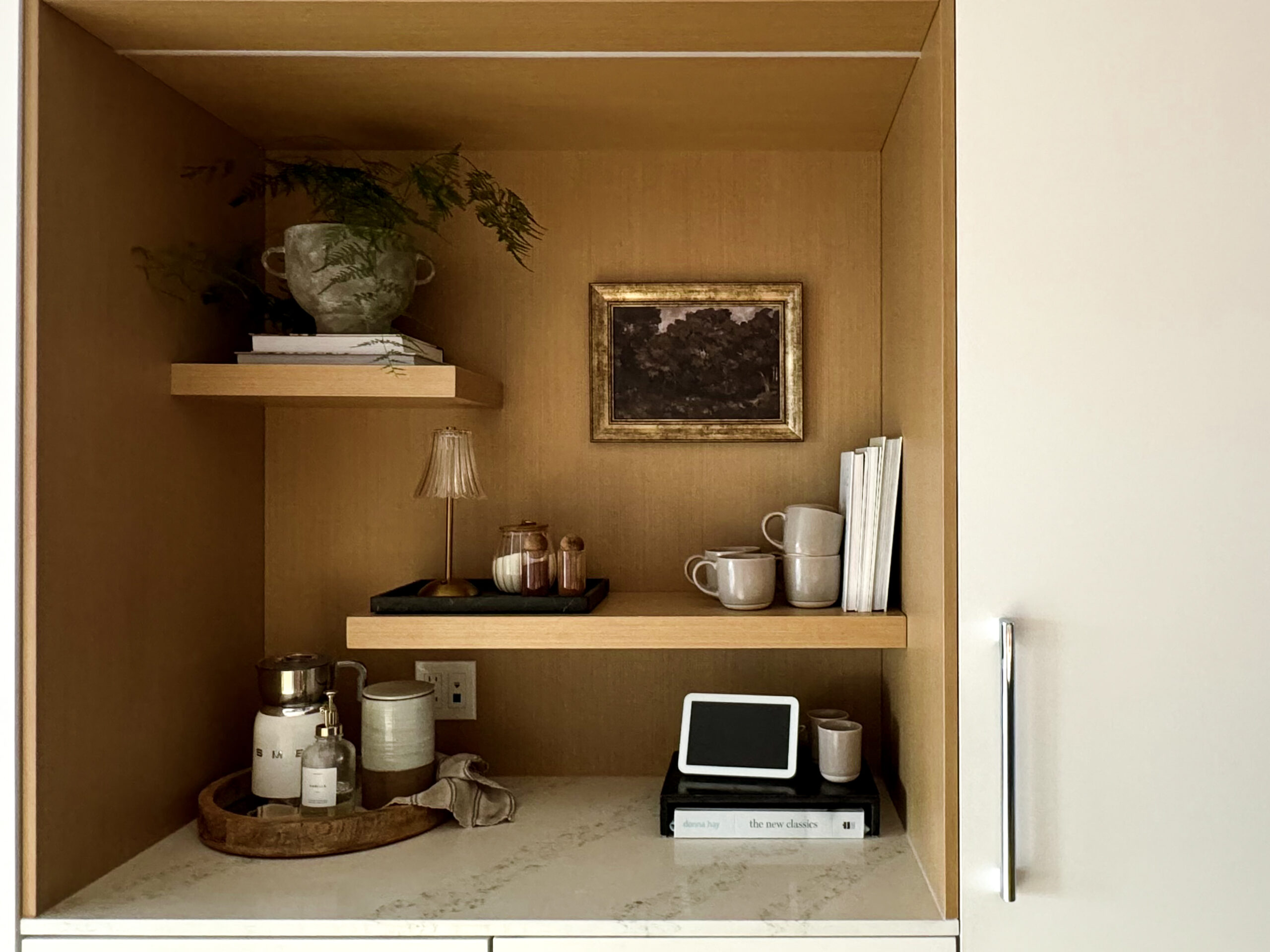 a tea bar decked out with mugs, milk frother and more.