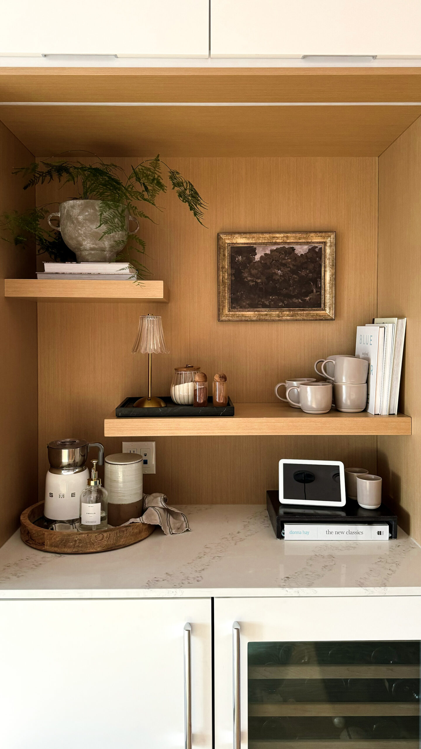 a tea bar decked out with mugs, milk frother and more.