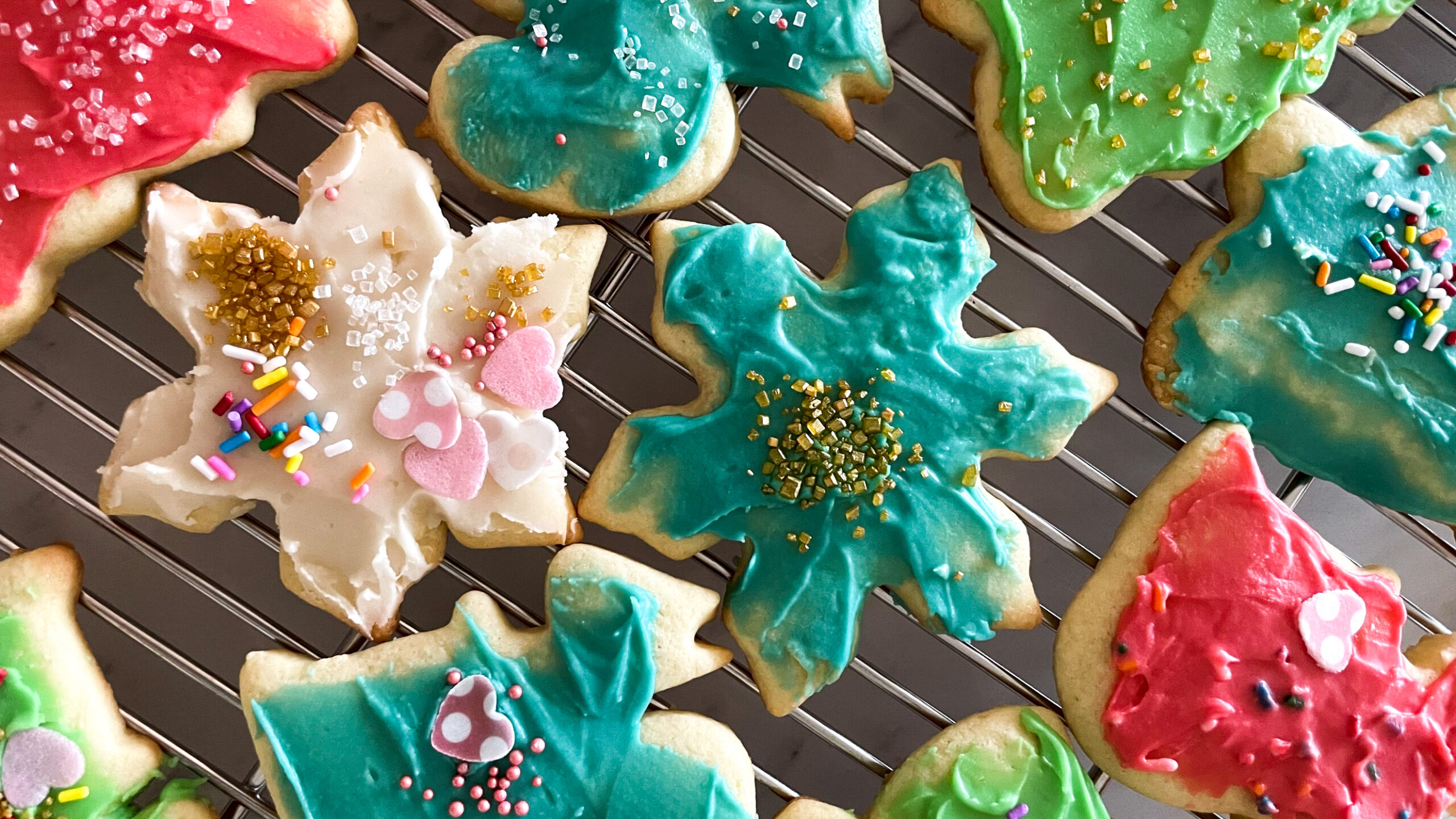 sugar cookies decorated for the holidays. Trees stars, squirrels, all in different colours.