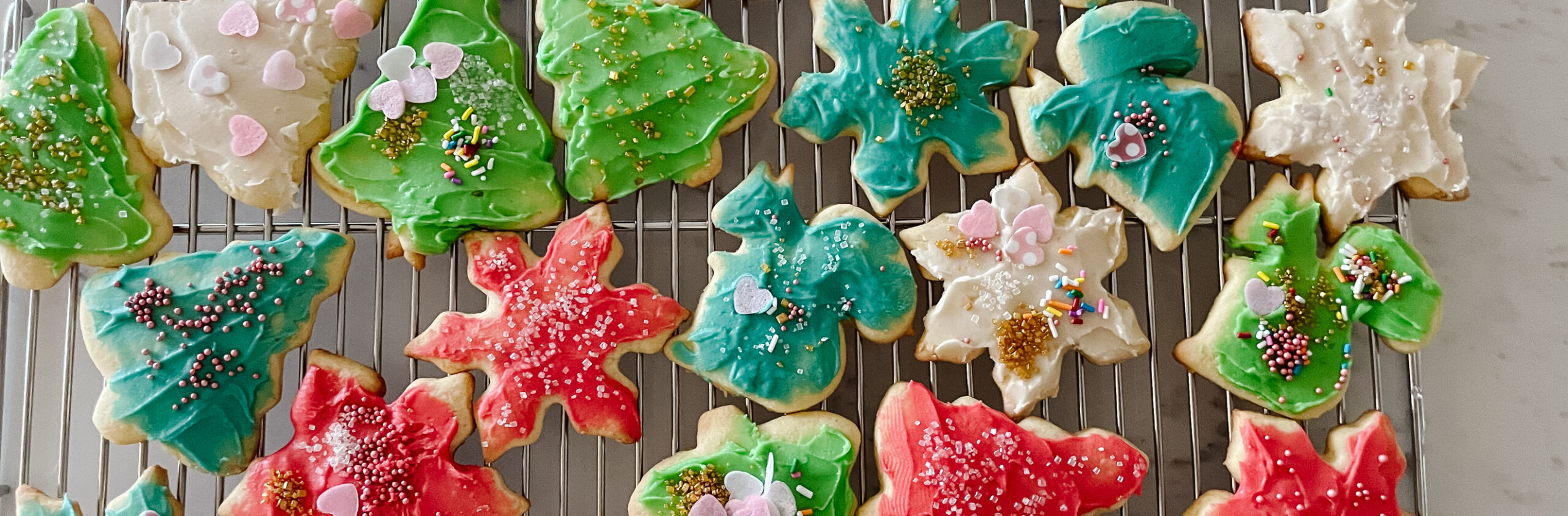 sugar cookies decorated for the holidays. Trees stars, squirrels, all in different colours.