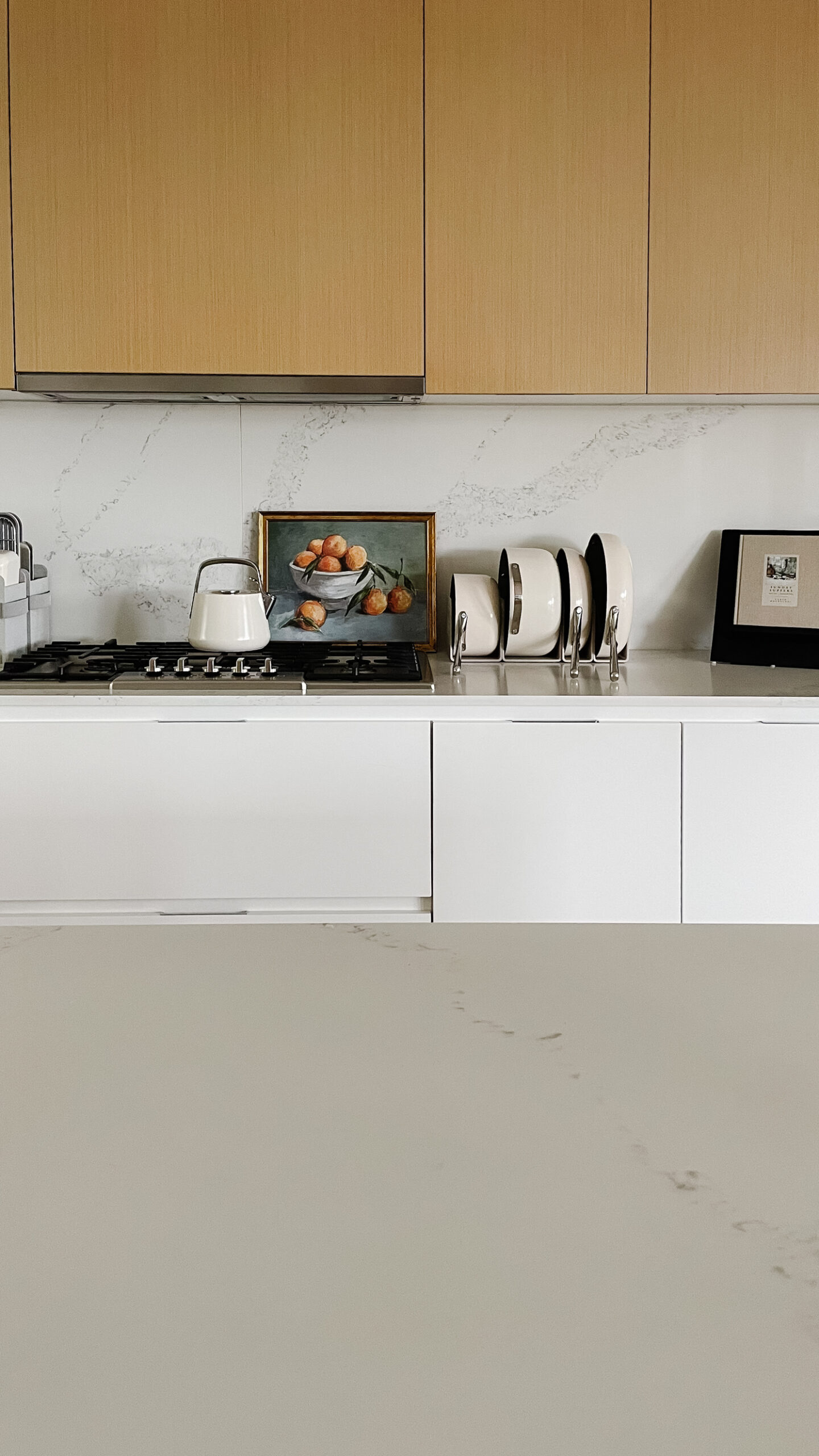 MY complete caraway kitchen pictured - a tea kettle, baking trays and dishes, and pots and pans