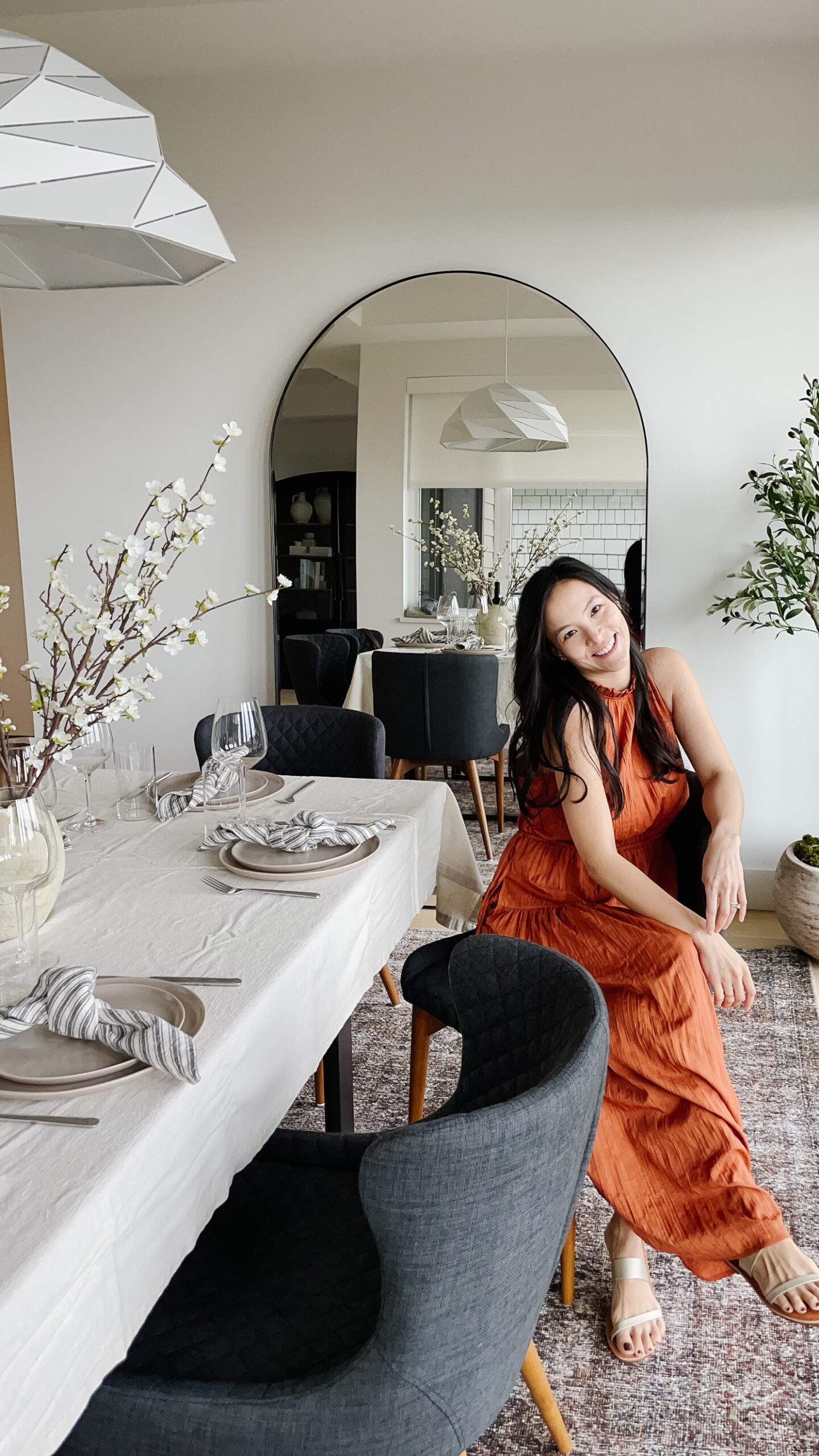 Signed Samantha sitting in the dining room with her gap clothes including a beautiful dress, market bag, and spring metallic sandals