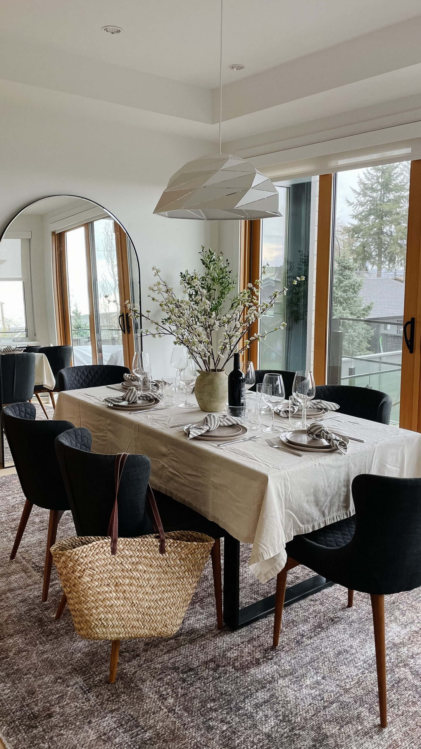 spring dining room table set with flowers, a market bag, floor length mirror and beautiful new carpet