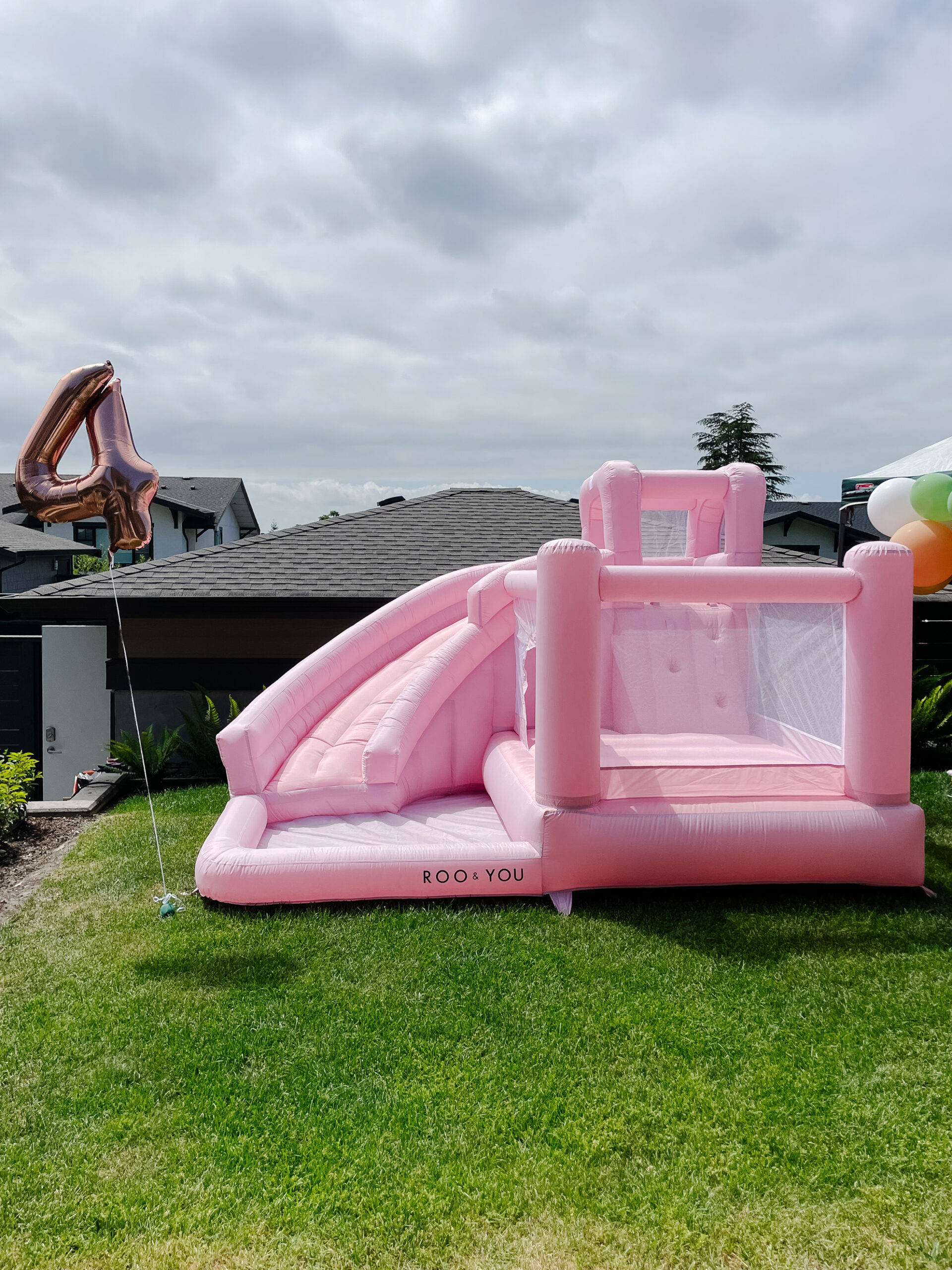 Bounce house at a little girl's 4th birthday party which was fairy garden themed