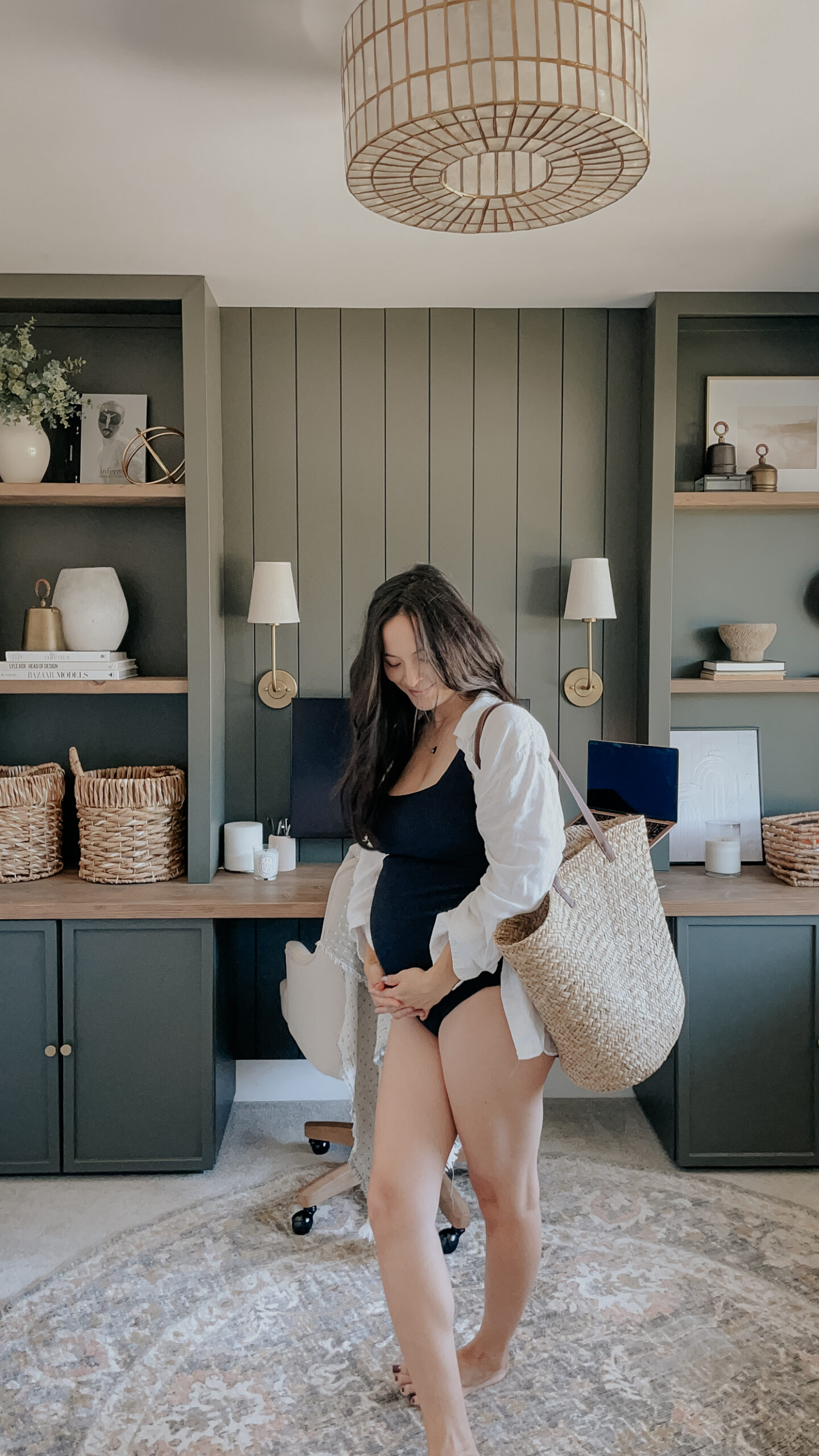 summer must-have's include a maternity swim suit and straw bag - such as what the girl in the image is wearing