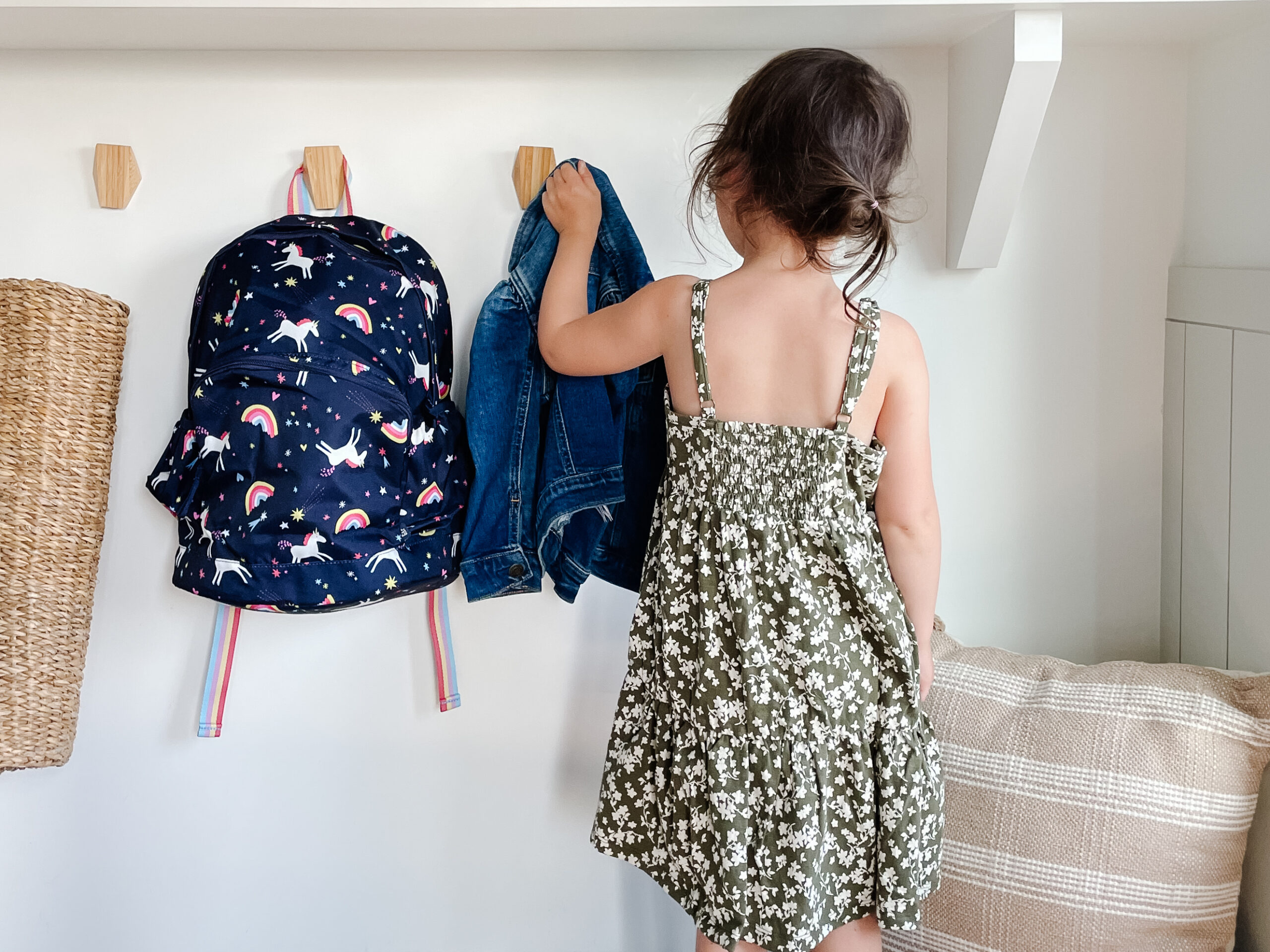 Little girl grabbing her jacket and back pack for back-to-school outfits with the Gap