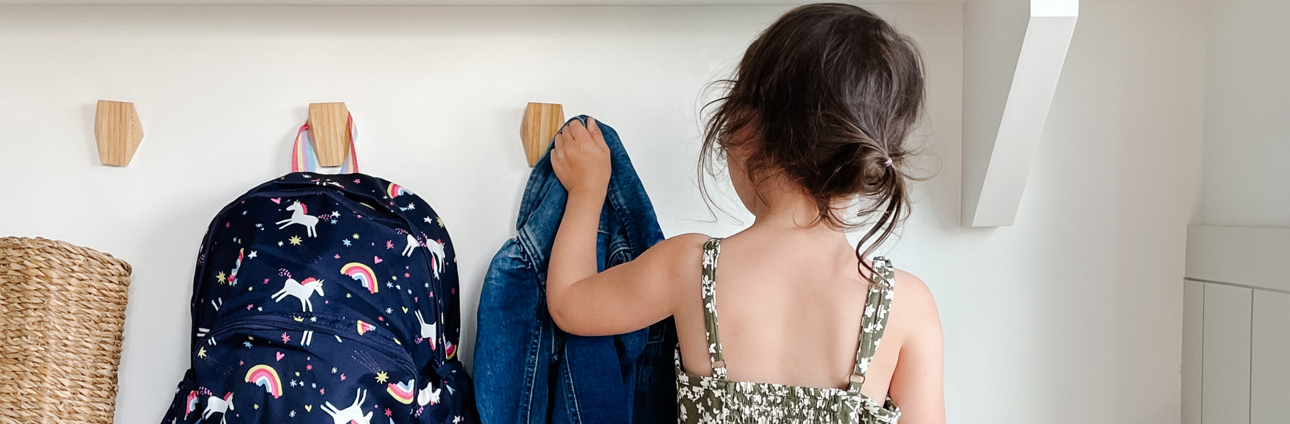 Little girl grabbing her jacket and back pack for back-to-school outfits with the Gap