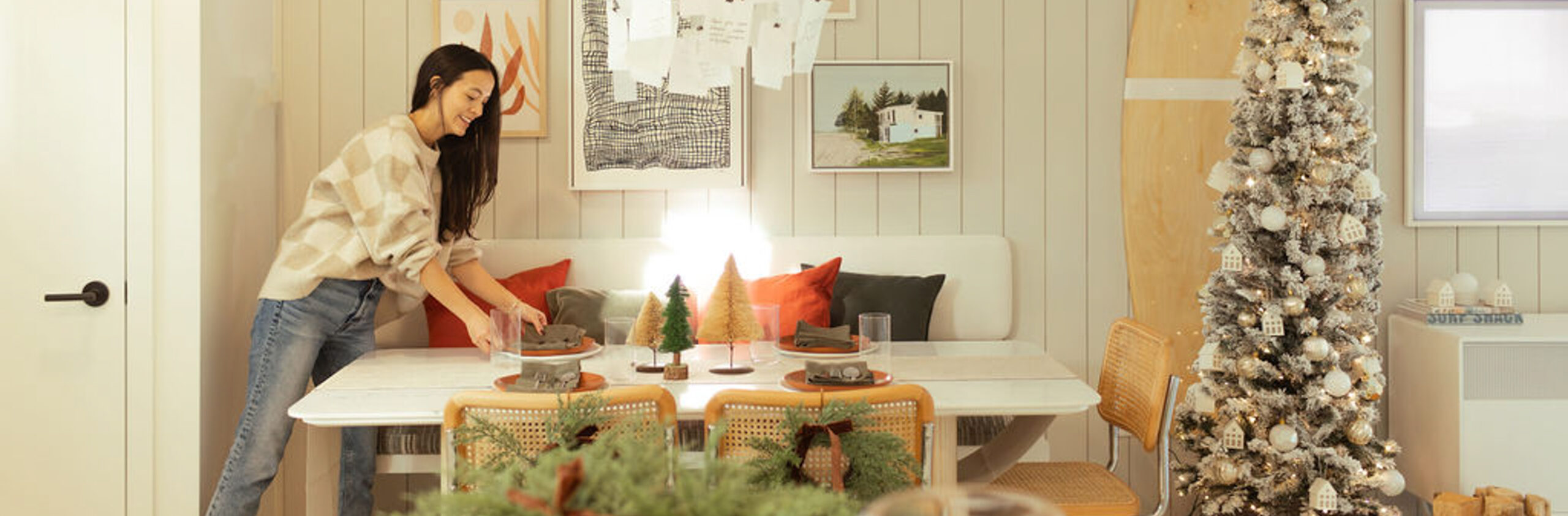 woman setting a table in the dining area of a townhome - Eastwoods in Maplewood North Vancouver