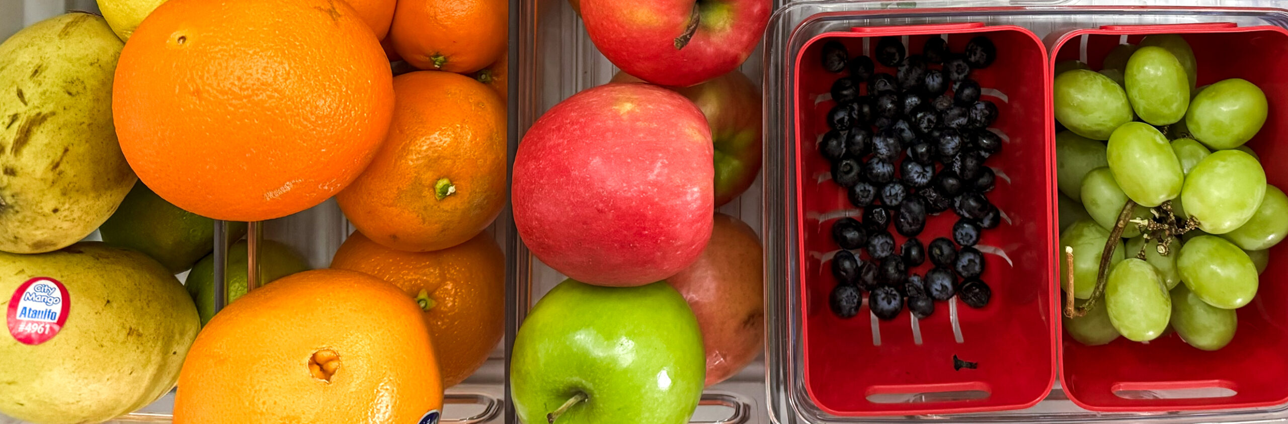 using plastic containers to organize the fruit in your fridge