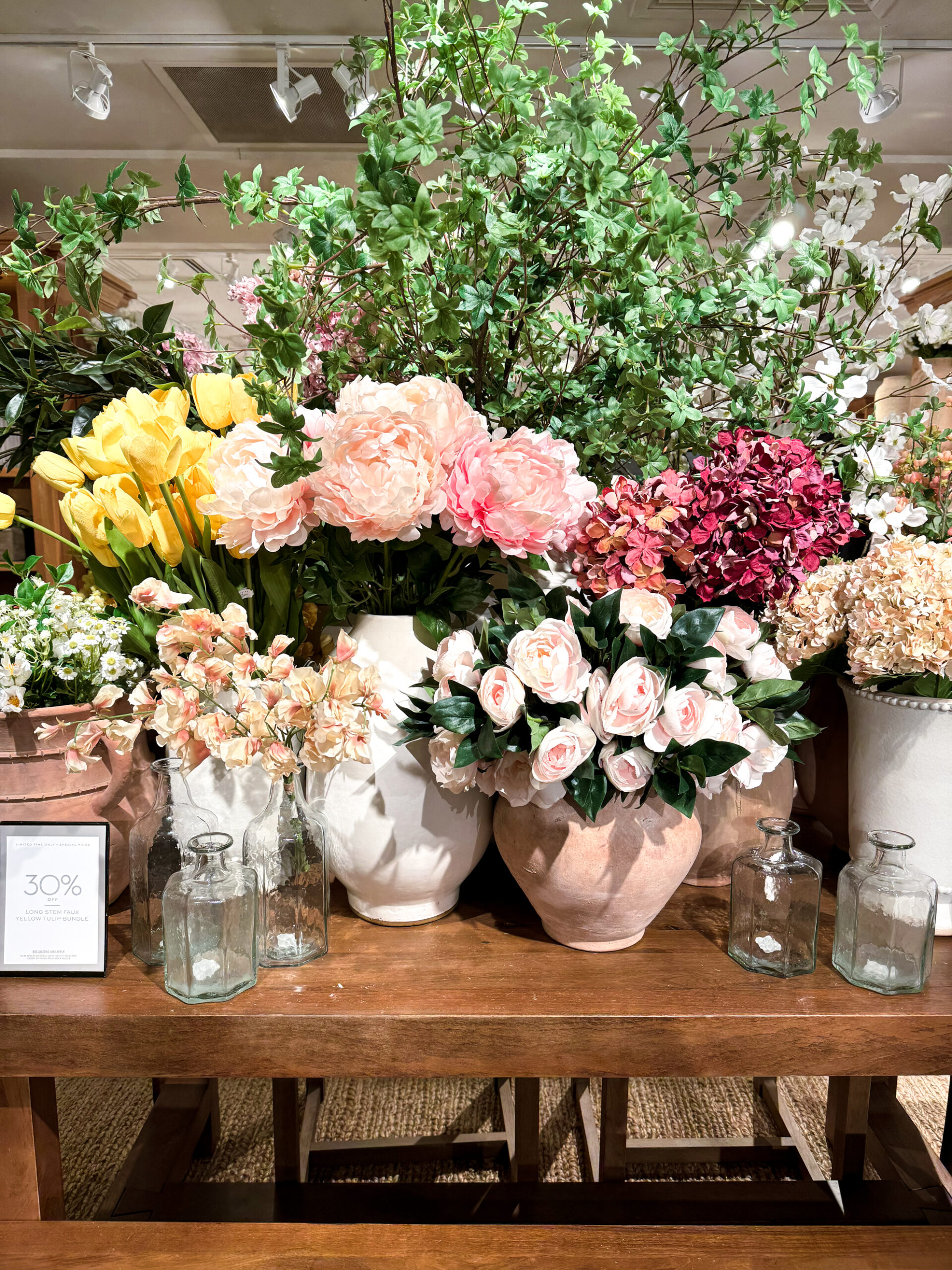 faux spring florals arranged in vases on a table. Peonies, roses, and more. so colourful and so beautiful.